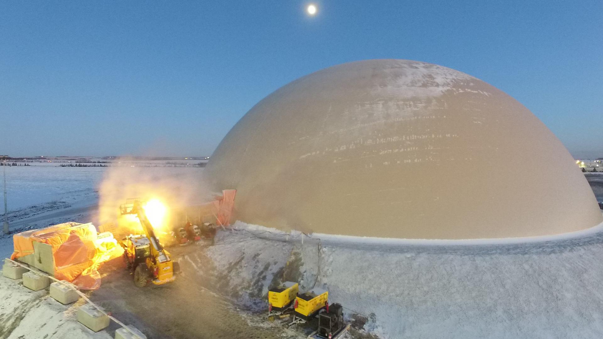 Snow highlights the elegant lines of the transverse Airform of this 182-foot diameter Monolithic Dome frac sand storage in Alberta, Canada.