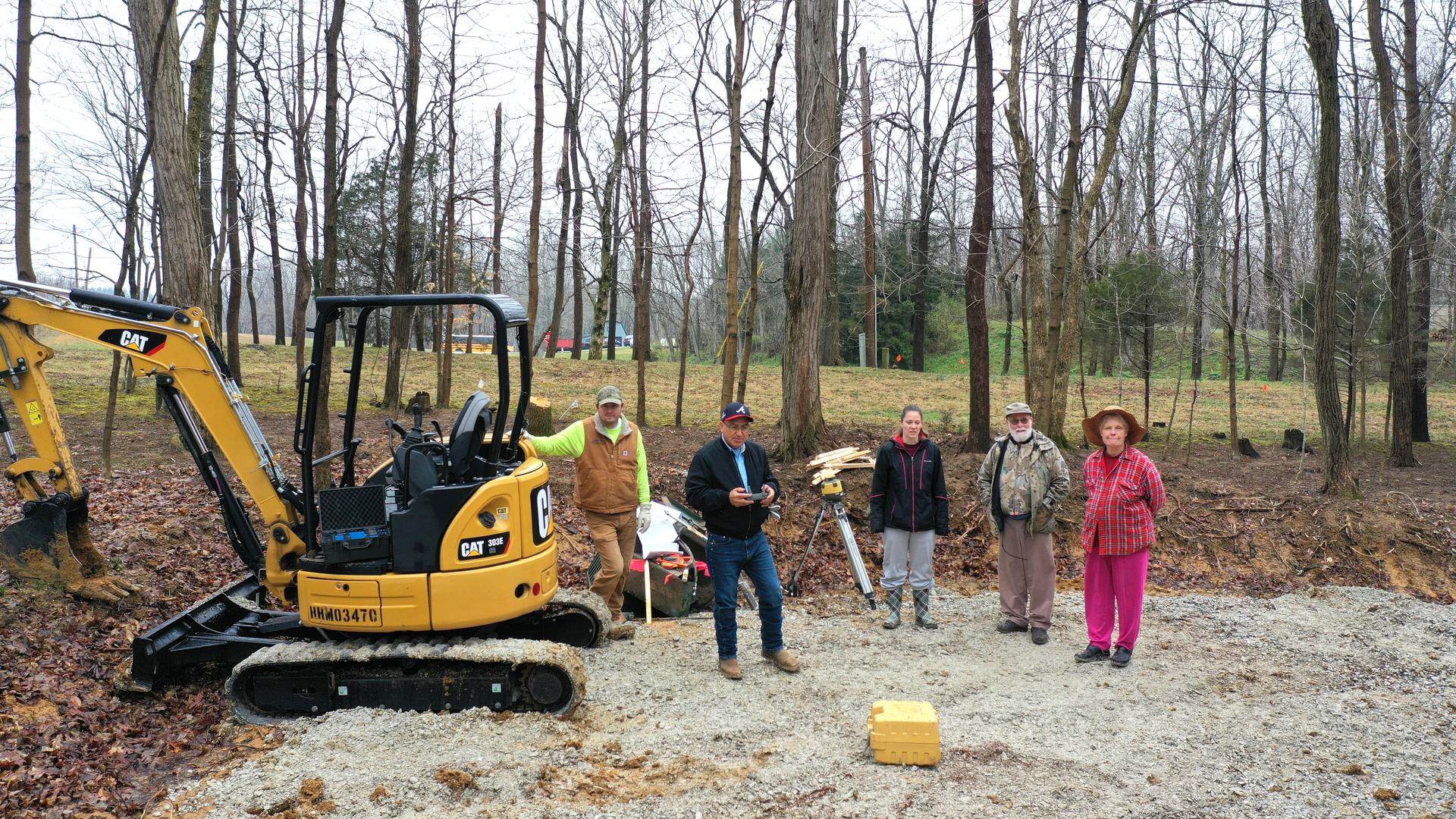 Crew from Monolithic Constructors, inc. and soon-to-be dome home owners standing at the site of their new home.