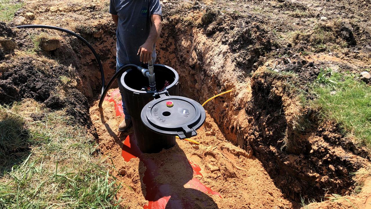 Large propane tank in the hole being connected to the hot tub heater, grill and burner, ready to be buried.