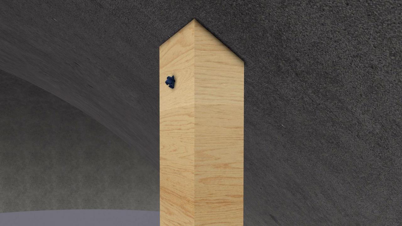 A framing board is attached with a concrete anchor directly to the Monolithic Dome shell.